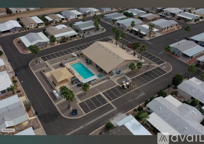 A bird's eye view of a neighborhood with a pool and apartment buildings.