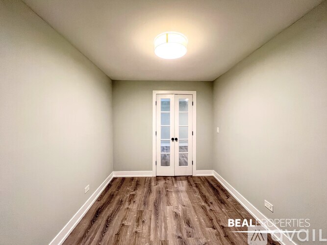 A room with a door and a light on the ceiling.