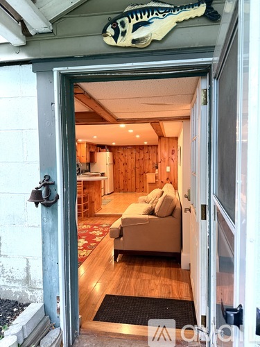 A room with a couch and a wooden wall.