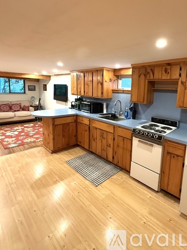 A kitchen with wooden cabinets and a white dishwasher.