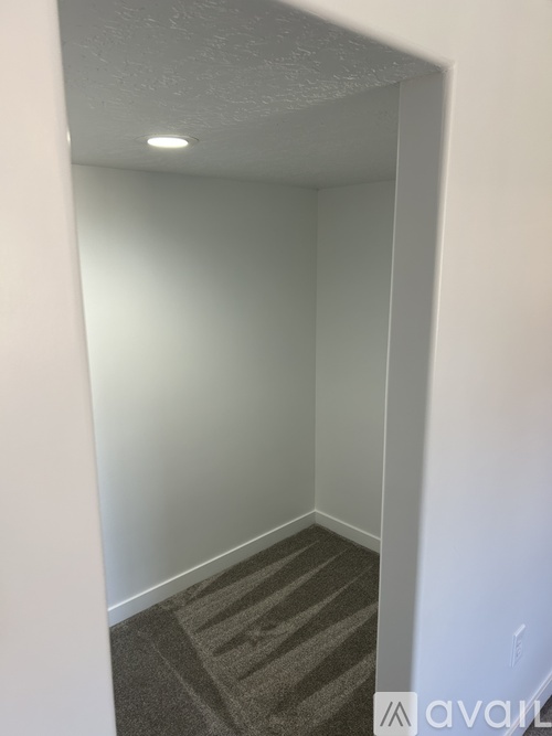 A room with a carpeted floor and white walls.