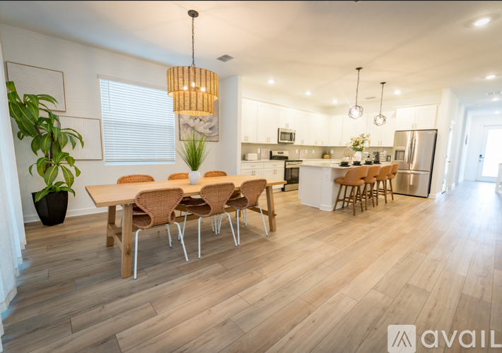 A modern kitchen with a dining table and chairs.