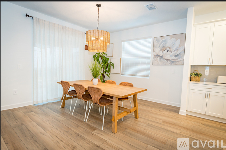 A dining room with a wooden table and chairs.