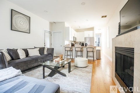 A living room with a grey couch and a coffee table.