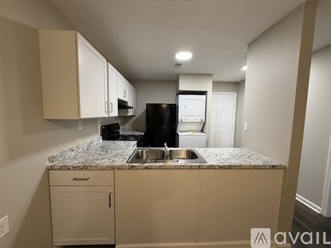 A kitchen with a granite countertop and a sink.