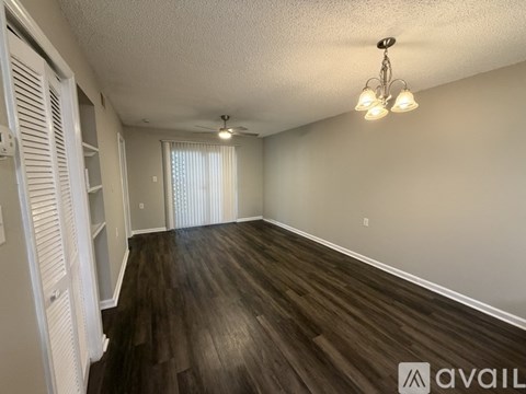 A room with wooden floors and a chandelier.