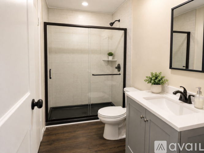 A bathroom with a white toilet and a white sink.
