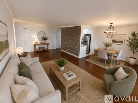 A living room with a grey couch, a coffee table, and a dining table with chairs.