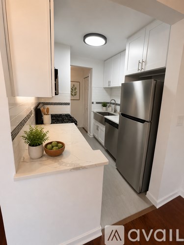 A kitchen with a refrigerator, stove, and countertop.