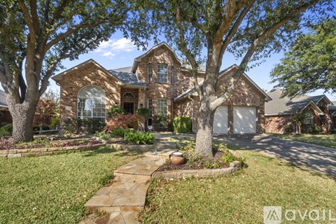 A large house with a stone pathway leading to the front door.