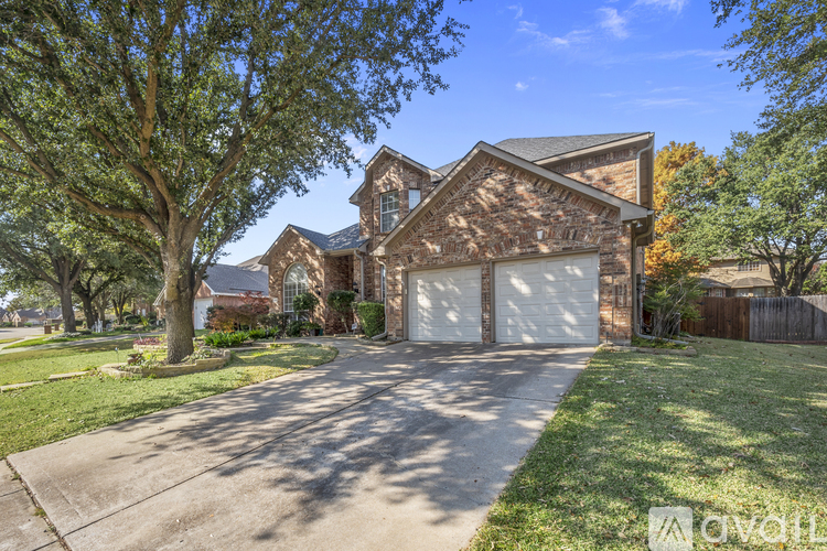 A large house with a driveway in front of it.