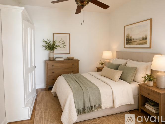 A bedroom with a bed, nightstand, and a ceiling fan.