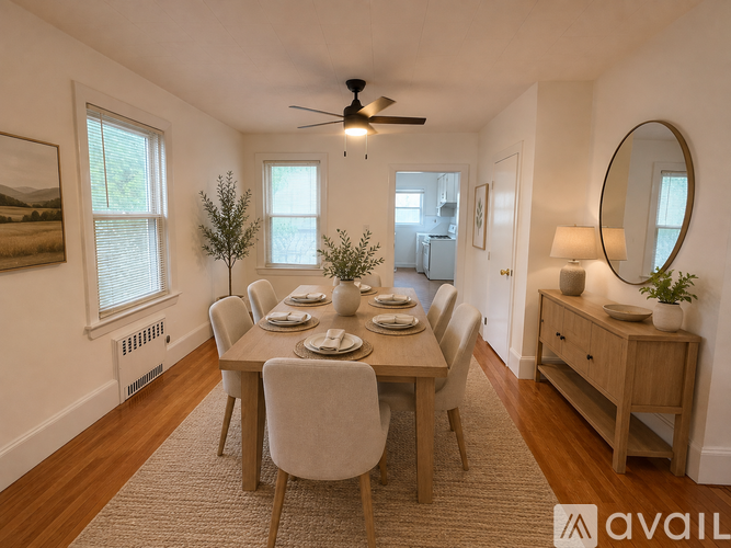A dining room with a table set for six and a fan on the ceiling.