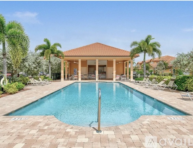 A pool with a house in the background.
