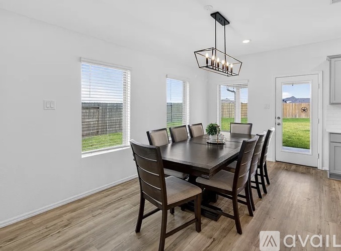 A dining room with a table set for six.