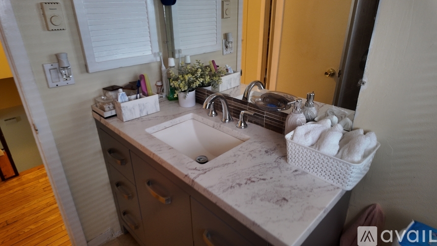 A bathroom with a marble countertop and a sink.