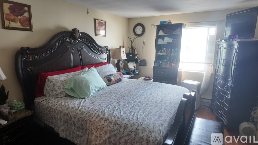 A bedroom with a large bed and a window.