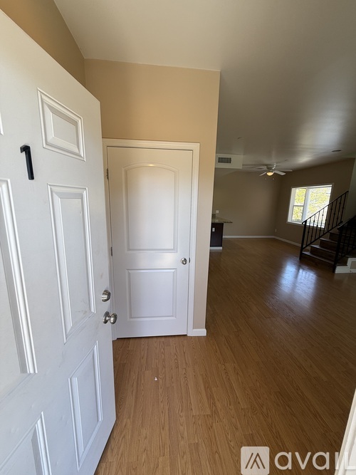 A white door with a black handle is on the left and a white door with a silver handle is on the right.