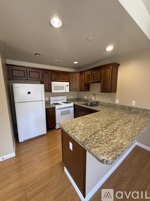 A kitchen with granite countertops and stainless steel appliances.