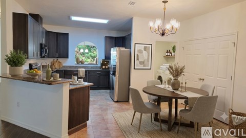 A kitchen with a table and chairs in the middle of the room.