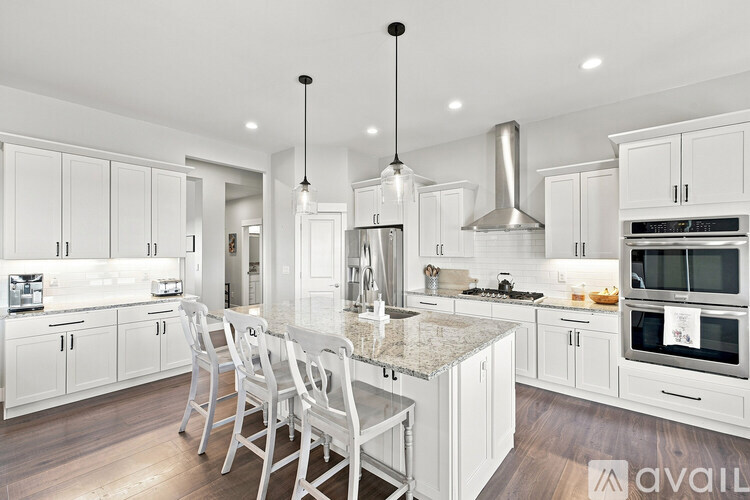 A modern kitchen with white cabinets and a central island.