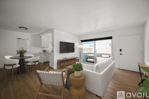 A modern living room with a white sofa, a wooden table, and a television mounted on the wall.