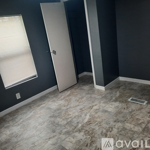 A room with a marble floor and a white door.