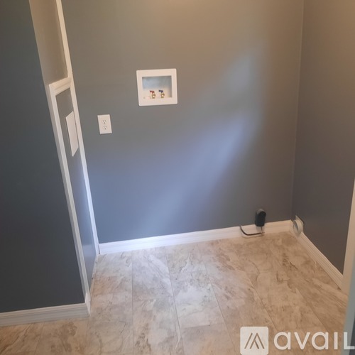 A room with a tiled floor and a picture on the wall.