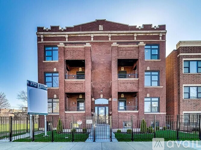 A brick building with a sign in front that says "Avail".