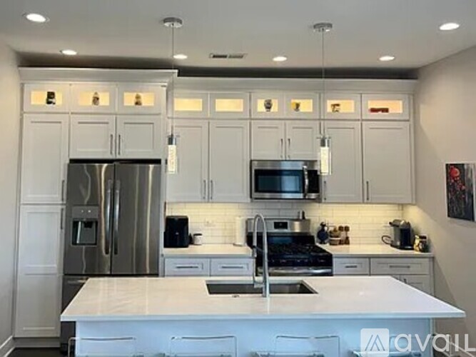 A kitchen with white cabinets and appliances.