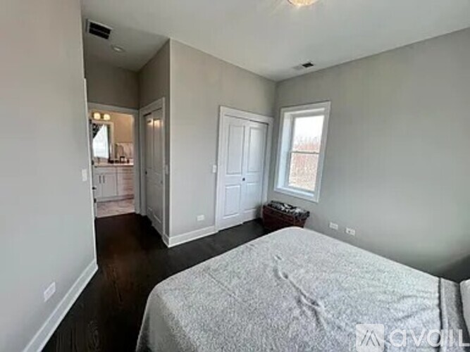 A bedroom with a bed, dresser, and mirror.