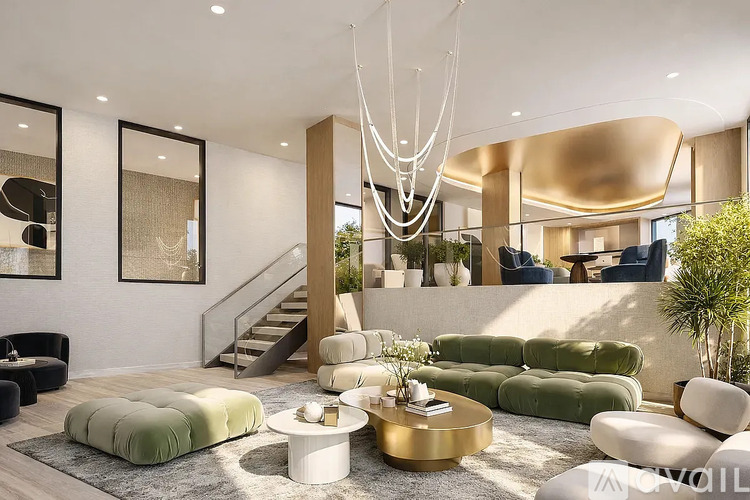 A modern living room with a green sofa, a white coffee table, and a gold chandelier.