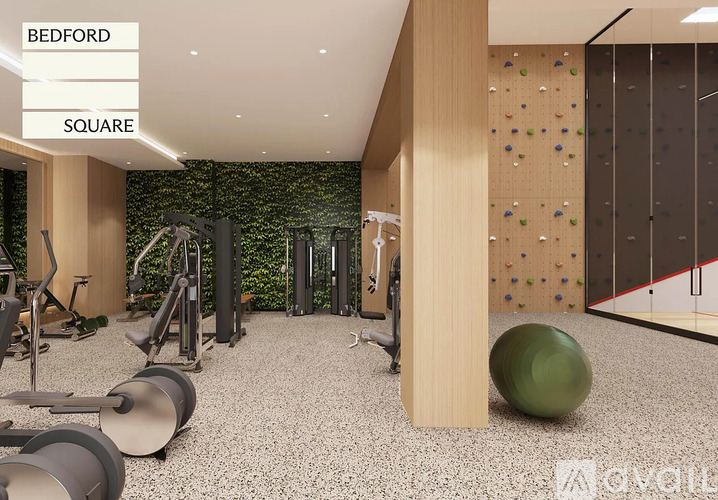 A gym with a green wall and a climbing wall.