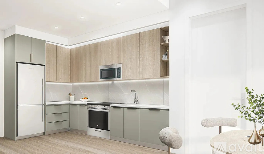 A modern kitchen with a refrigerator, oven, and a sink.