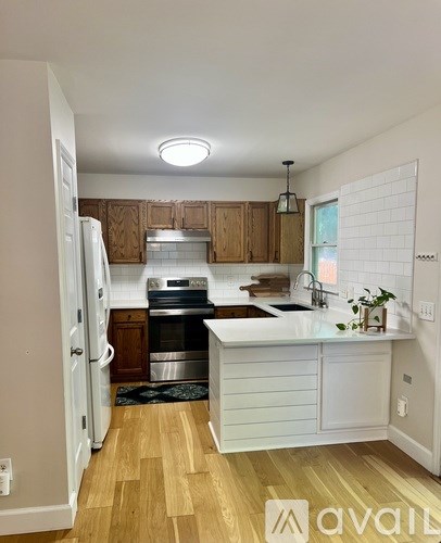 A kitchen with wooden cabinets and a white countertop.