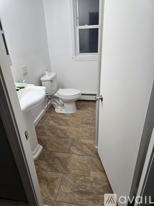A bathroom with a toilet and sink.