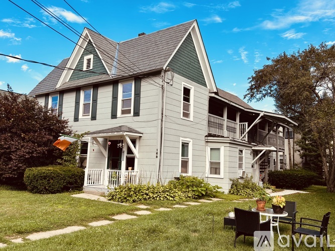 A house with a porch and a small garden in front.