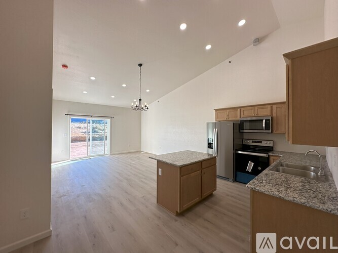 A kitchen with wooden cabinets and a granite countertop.