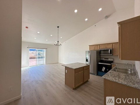 A kitchen with wooden cabinets and a granite countertop.