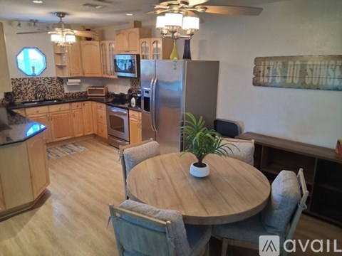 A kitchen with a table and chairs in the middle of the room.