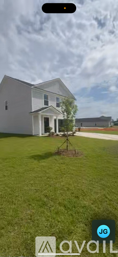 A house with a tree in front of it.