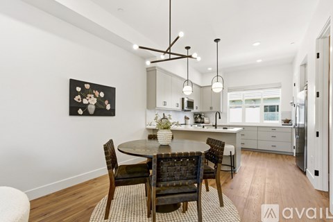 A modern kitchen with a dining table and chairs.