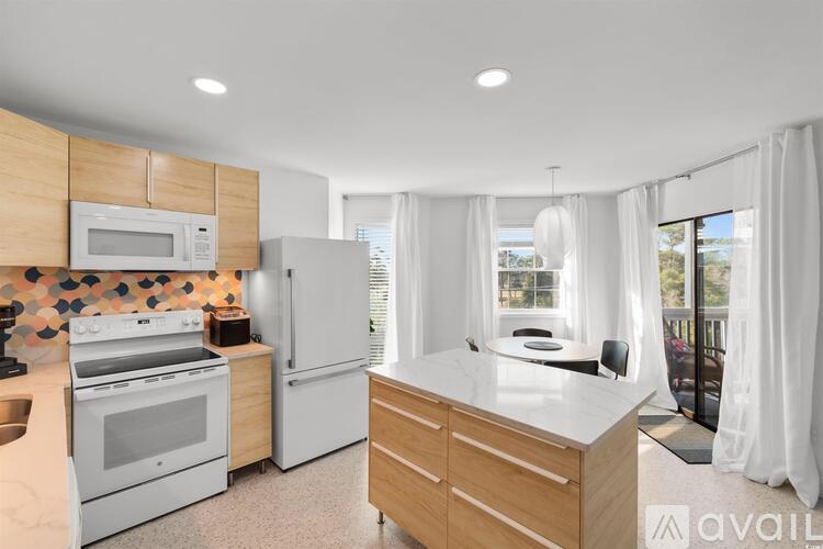 A kitchen with wooden cabinets and white appliances.