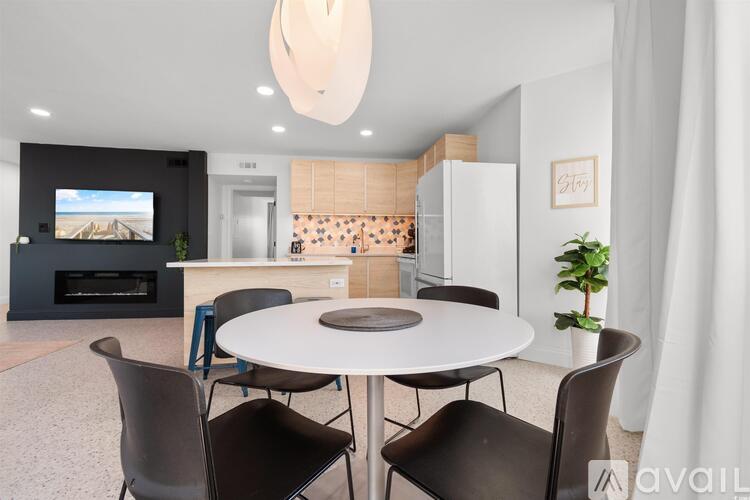 A modern dining room with a round table and chairs.