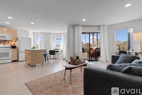 A modern living room with a grey sofa and a coffee table.