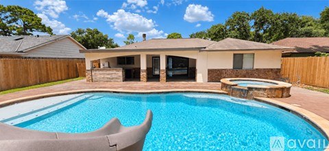 A pool in a backyard with a house in the background.