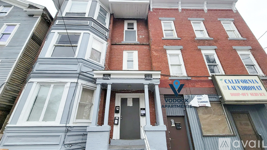 A multi-story building with a laundromat on the ground floor.