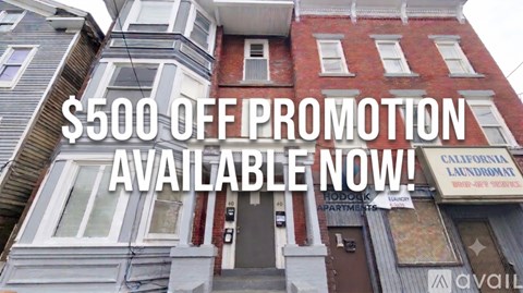 A building with a sign that says $500 off promotion available now.