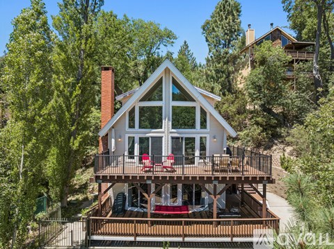 A house with a balcony and a red couch.