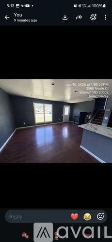A room with wooden flooring and a large window.